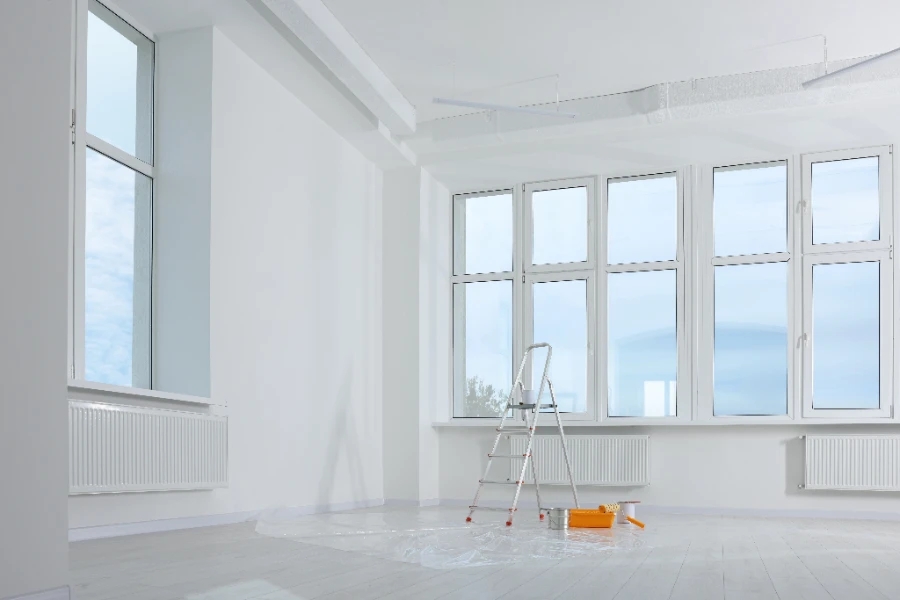 stepladder-and-painting-tools-near-window-in-empty-2026-01-27-21-22-01-utc